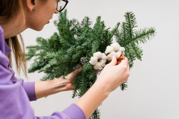 Step-by-step guide on adding branches to artificial Christmas tree